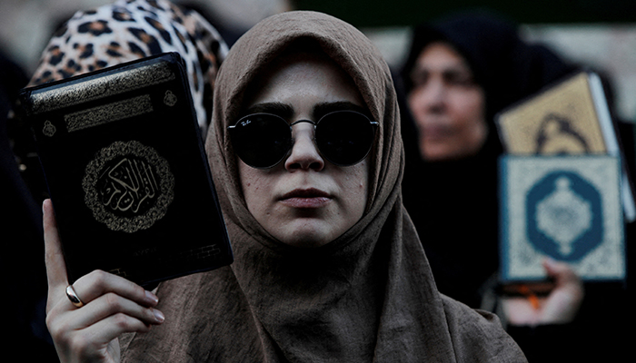 Protesters hold copies of the Quran as they demonstrate outside the Consulate General of Sweden in Istanbul, Turkey, July 30, 2023. — Reuters