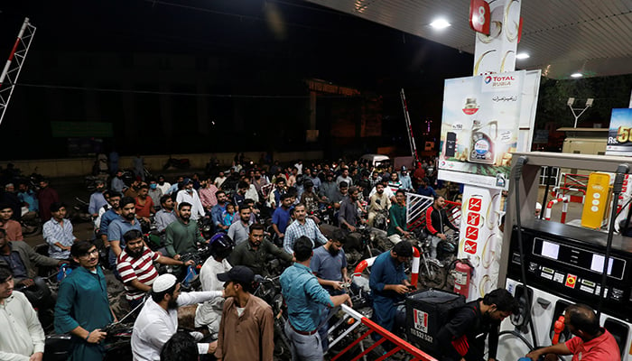 People wait for their turn to get petrol at a petrol station, after Pakistan Petroleum Dealers Association (PPDA) announced a countrywide strike, in Karachi, November 24, 2021. — Reuters