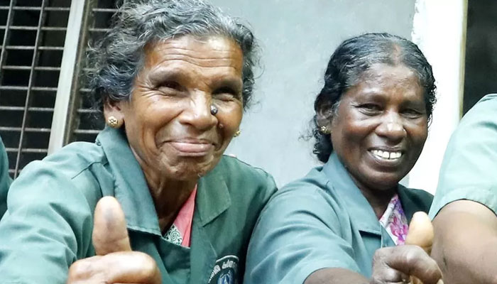 Two of the 11 women pose to celebrate lottery win in Kerala. — BBC/File