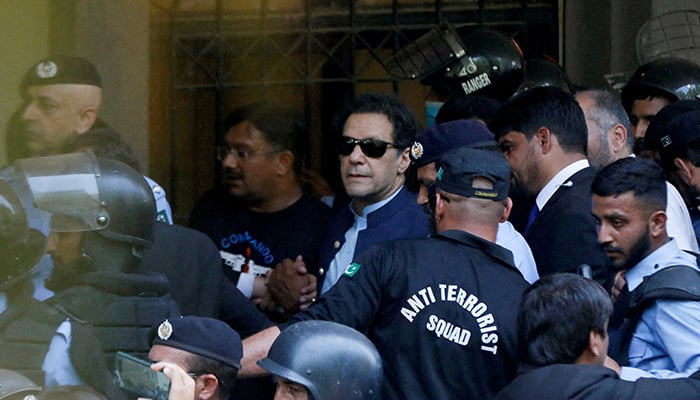 Security officers escort former prime minister Imran Khan as he appeared in Islamabad High Court, Islamabad, on May 12, 2023. — Reuters