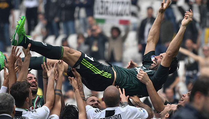 (FILES) Juventus´ goalkeeper from Italy Gianluigi Buffon is lift in the air by teammates during the victory ceremony following the Italian Serie A last football match of the season Juventus versus Verona, on May 19, 2018 at the Allianz Stadium in Turin. Legendary Italian goalkeeper Buffon announced retirement on social media on August 2, 2023.—AFP