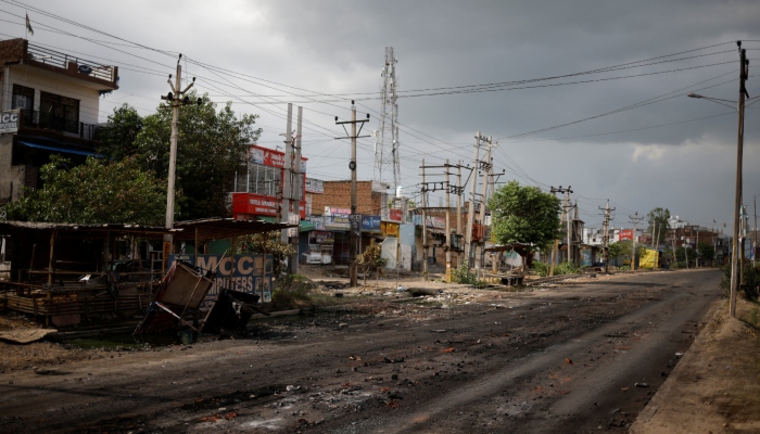 A burnt shop is seen next to a deserted road during a curfew imposed by the authorities following clashes between Hindus and Muslims in Nuh district of the northern state of Haryana, India, August 1, 2023. — Reuters