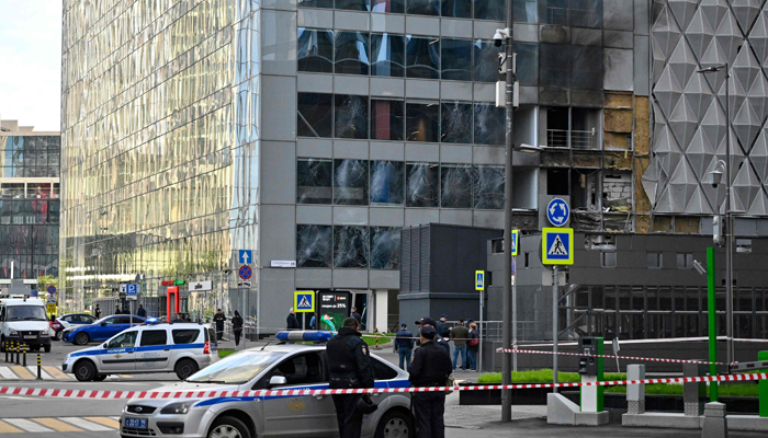 Police officers block off an area around a damaged office block of the Moscow International Business Center following a reported drone attack in Moscow on July 30, 2023. — AFP