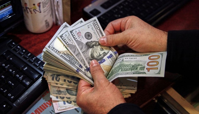 A money changer counts U.S. dollar banknotes at a currency exchange office in Ankara, Turkey November 11, 2021. — Reuters