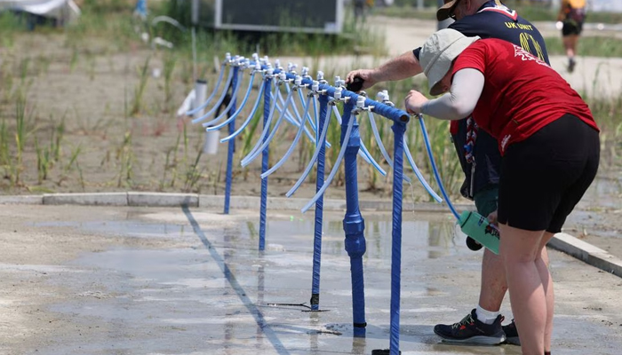 Participants for the 25th World Scout Jamboree fill water bottles at a water supply zone of a camping site in Buan, South Korea, on August 2, 2023.   — Yonhap