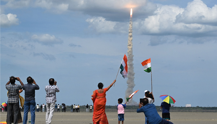 People wave Indian flags as an Indian Chandrayaan-3 spacecraft lifts off from the Satish Dhawan Space Centre in Sriharikota, an island off the coast of southern Andhra Pradesh state on July 14, 2023. — AFP
