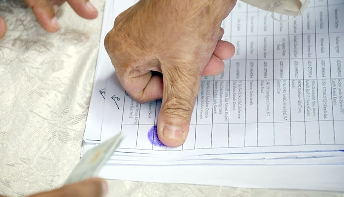 Voters cast their votes at a polling station during an election in Karachi, on June 15, 2023. — Online