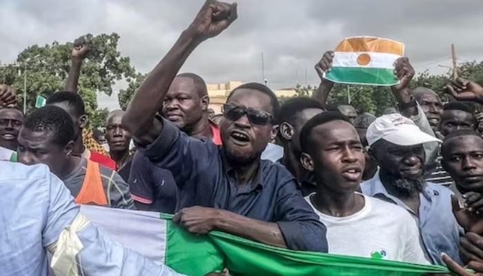 Supporters of Nigers coup leaders during a rally at a stadium in Niamey, Niger, August 6, 2023. — AFP