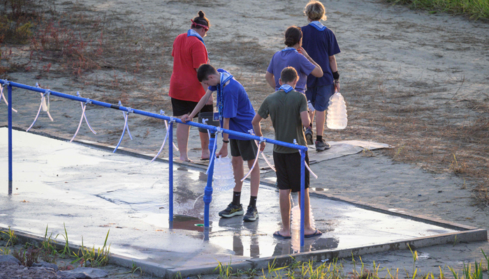 Scouts fill up containers of water at the campsite of the World Scout Jamboree in Buan, North Jeolla province on August 5, 2023. — AFP