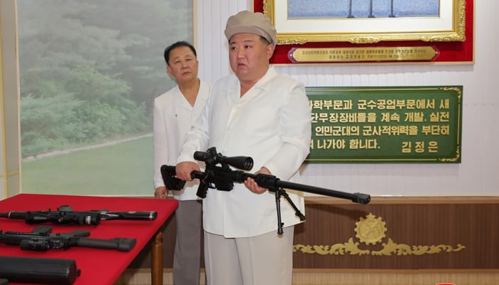 This photo taken on August 6, 2023, shows North Korean leader Kim Jong-un while carrying a long-range sniper rife during his visit to weapons production facilities. — KCNA