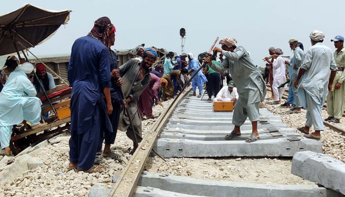 Labourers use heavy machinery to repair the mainstream track of Pakistan Railways on Monday, August 7, 2023. — PPI