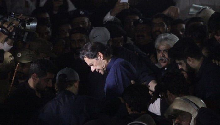 Former Prime Minister, Imran Khan, along with his supporters walks as he leaves the district High Court in Lahore, Pakistan February 20, 2023. — Reuters