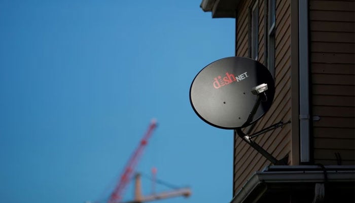 A Dish Network receiver hangs on a house in Somerville, Massachusetts, US, February 21, 2017. Reuters/File