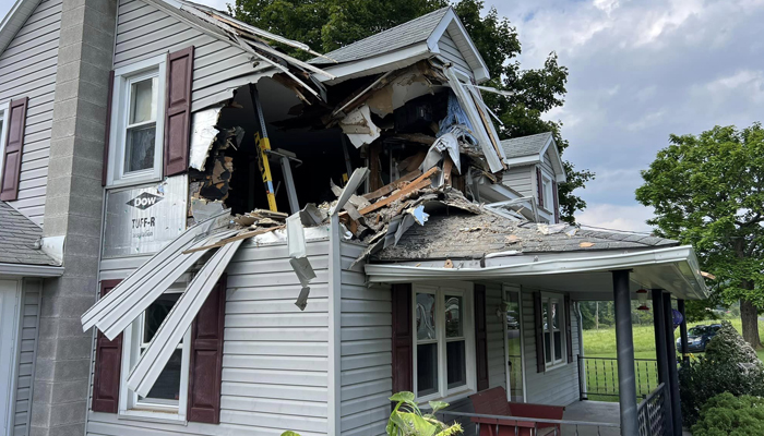 A house can be seen where a car was smashed into the second floor in Lewistown Pennsylvania in this picture released on August 7, 2023. — Facebook/Junction Fire Company