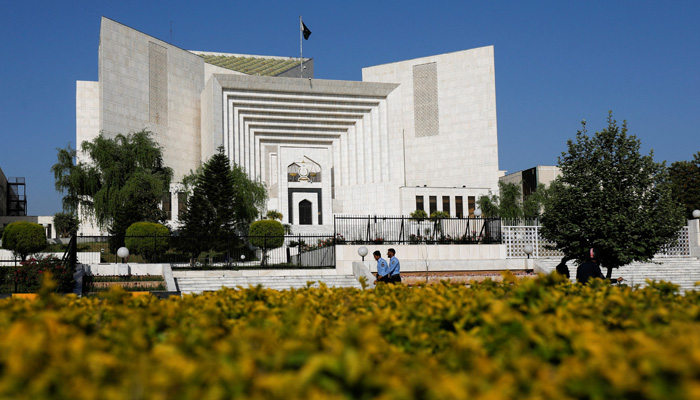 Police officers walk past the Supreme Court of Pakistan building, in Islamabad, April 6, 2022. — Reuters