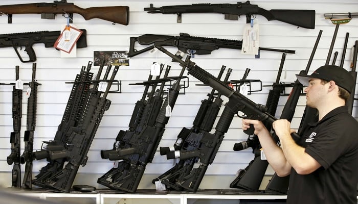 A salesman clears the chamber of an AR-15 in 2016 at a gun store in Provo, Utah. — Reuters/File