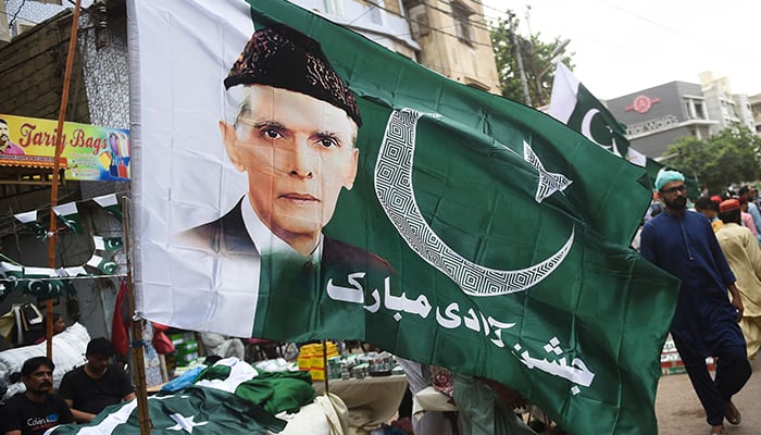 People throng a market where vendors sell Pakistan´s national flags in Karachi on August 11, 2023, ahead of the countrys 77th Independence Day. — AFP