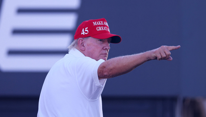 Former President Donald Trump waves to the crowd on the 16th tee during day three of the LIV Golf Invitational - Bedminster at Trump National Golf Club on August 13, 2023, in New Jersey. — AFP