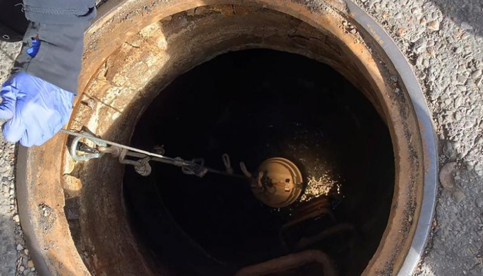 An open manhole is seen during some maintenance work in this undated image. — Reuters/File