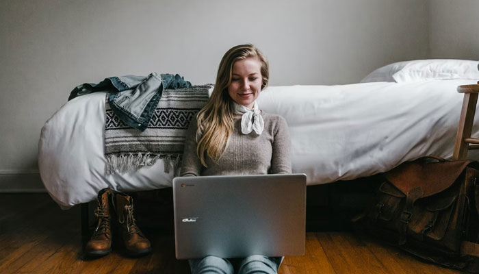 Representational image of a freelancer who is happy working from the comfort of her home. Unsplash