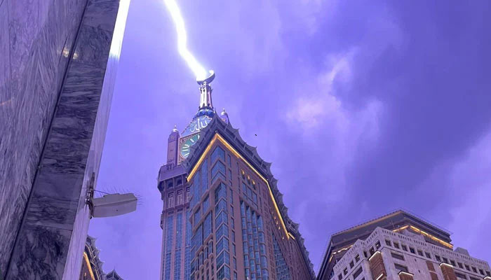 This picture shows the moment when a lightning bolt struck the Abraj Al-Bait, also known as the Clock Towers on August 22, 2023. — X/@HaramainInfo
