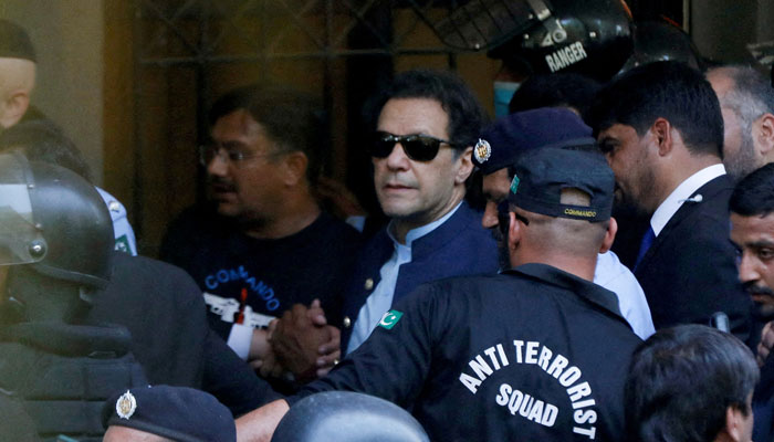 Security officers escort Pakistani former Prime Minister Imran Khan as he appeared in Islamabad High Court, Islamabad, Pakistan, May 12, 2023. — Reuters