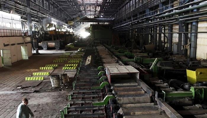 A man walks past machines at the hot strip mill department of the Pakistan Steel Mills (PSM) on the outskirts of Karachi. —Reuters/File