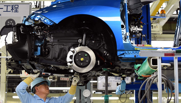 (FILES) An employee of Toyota Motors assembles FCV Mirai on its assembly line during the vehicle´s line-off ceremony at the Motomachi factory in Toyota city, Aichi prefecture on February 24, 2015.—AFP