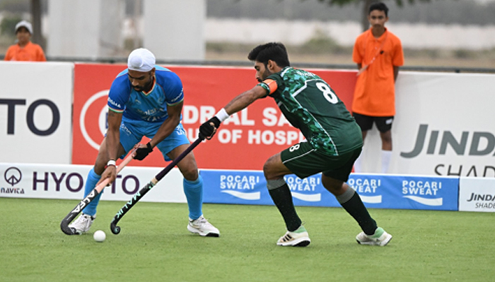 Pakistani hockey player tries to take the ball from Indian opponent. — Twitter/@@asia_hockey