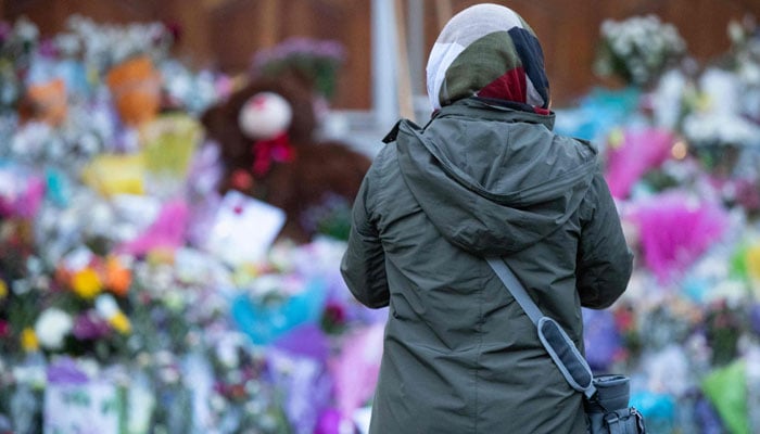 A woman pays her respects at the London Muslim Mosque during the multi-faith march to end hatred, after a man driving a pickup truck struck and killed four members of a Muslim family in London, Ontario, Canada on June 11, 2021. — AFP/File