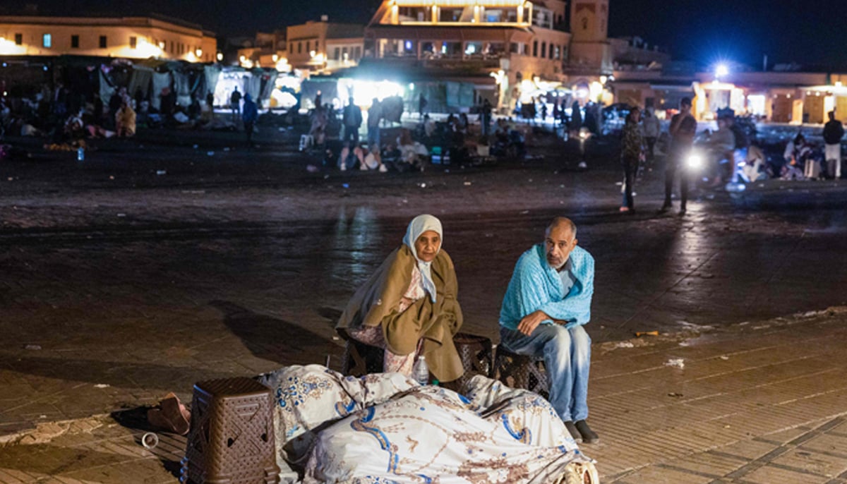 Residents take shelter outside at a square following an earthquake in Marrakesh on September 9, 2023. — AFP