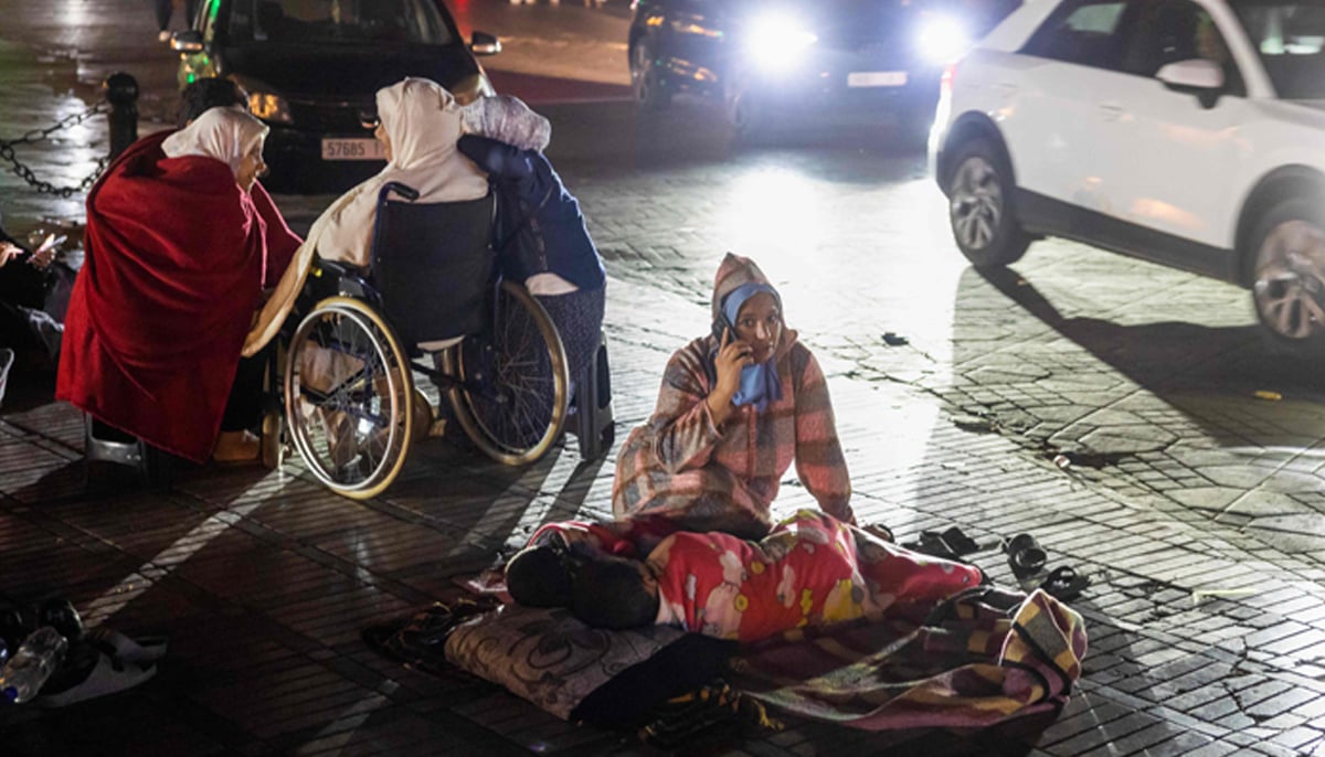 Residents take shelter outside at a square following an earthquake in Marrakesh on September 9, 2023. — AFP