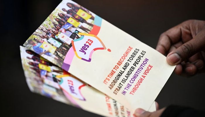 A Yes23 volunteer holds pamphlets while speaking with commuters about the upcoming Voice to Parliament referendum, in Melbourne, Australia August 30, 2023. — Reuters/File