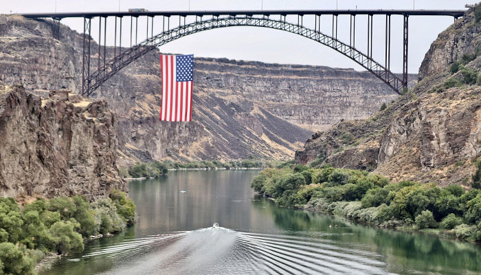 A giant 150x78 ft US flag suspended just to the west of the Perrine Bridge, over Snake River in Jerome and Twin Falls counites in Idaho, US as part of 9/11 remembrances in 2022. — X/@cjsurber