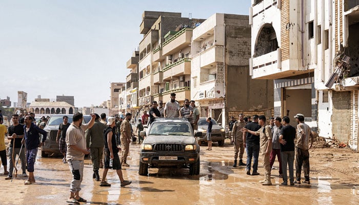 People inspecting damage in a flooded area in the eastern city of Derna, about 290 kilometres east of Benghazi, in the wake of the Mediterranean storm Daniel, on September 11, 2023. — AFP