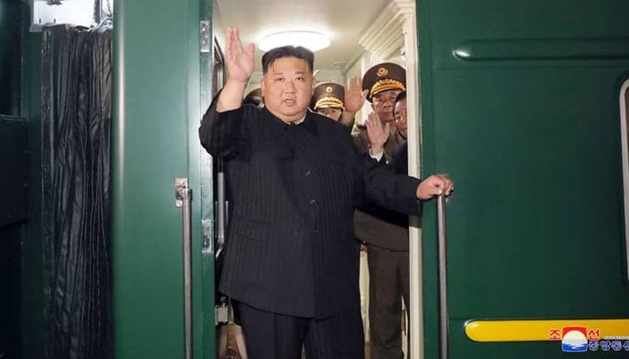 North Koreas leader Kim Jong-un waves as he departs by train from Pyongyang for a visit to Russia.—AFP