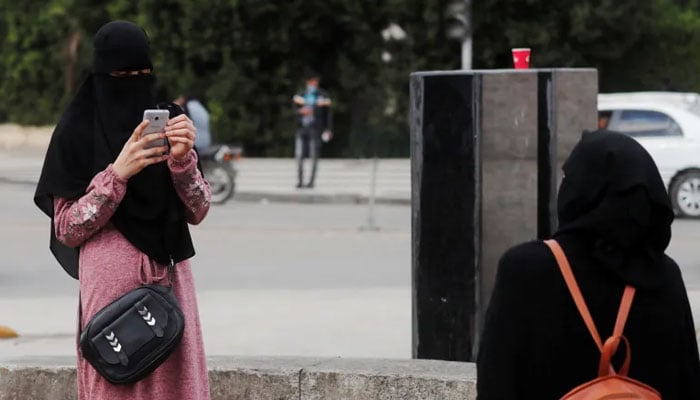 An Egyptian woman wearing a niqab takes pictures in Cairo. — Reuters/File