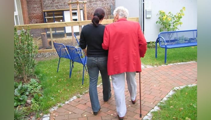 A dementia patient can be seen being walked by another person. — Pixabay/File