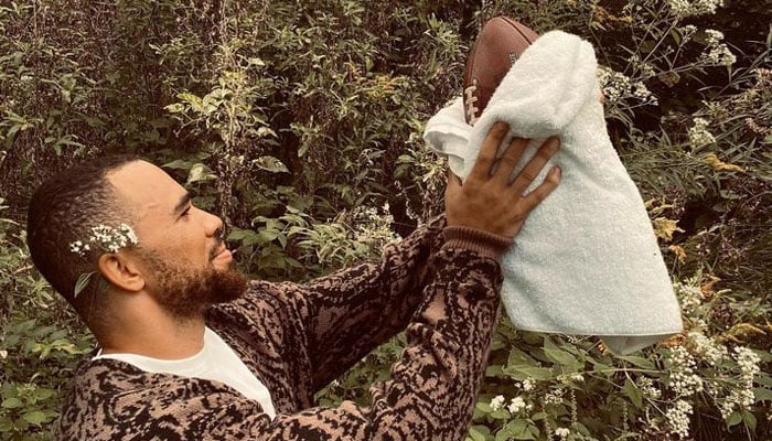 Indianapolis Colts tight end Kylen Granson poses with a football that he scored his first touchdown wrapped in a towel like a baby. — Instagram/@k_granson18