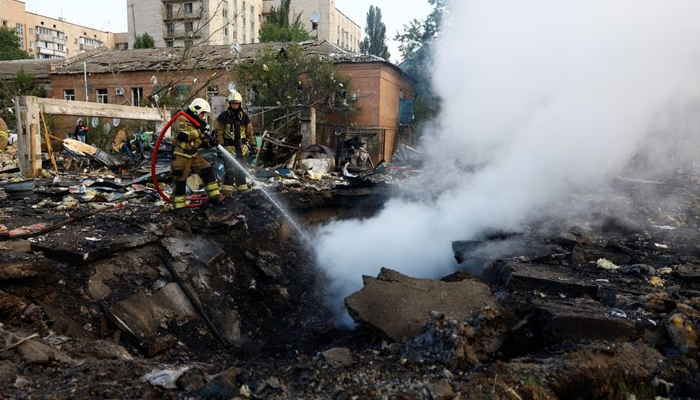 Firefighters work at a site in a residential area, damaged during a Russian missile strike in Kyiv, Ukraine September 21. — Reuters