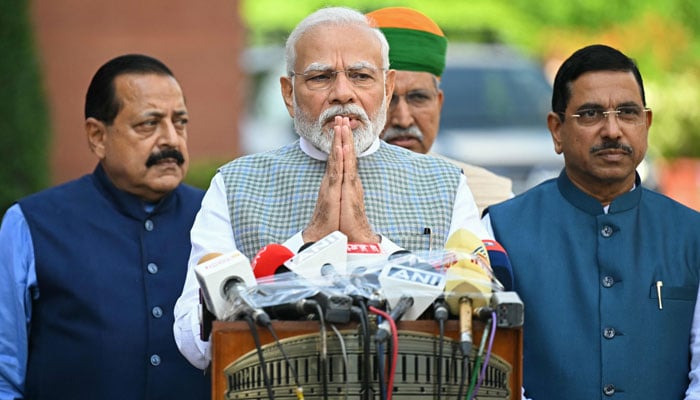 Indias Prime Minister Narendra Modi (C) along with lawmakers, addresses the media representatives upon his arrival to attend the special session of the parliament in New Delhi on September 18, 2023. — AFP