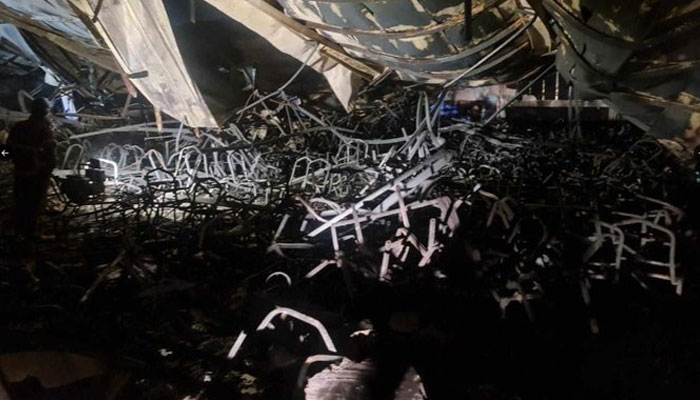 This picture shows charred chairs and other decorations inside the wedding hall after a horrific fire in Iraq. — X/@SardarSattar