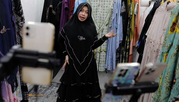 Bening Widayati, 40, sells clothes live on a social media platform inside her stall at the International Trade Center (ITC) mall in Jakarta, Indonesia, September 27, 2023.—Reuters