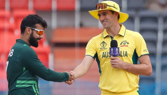 Pakistans stand-in captain Shadab Khan shakes hands with Australia skipper Pat Cummins at the toss. — PCB