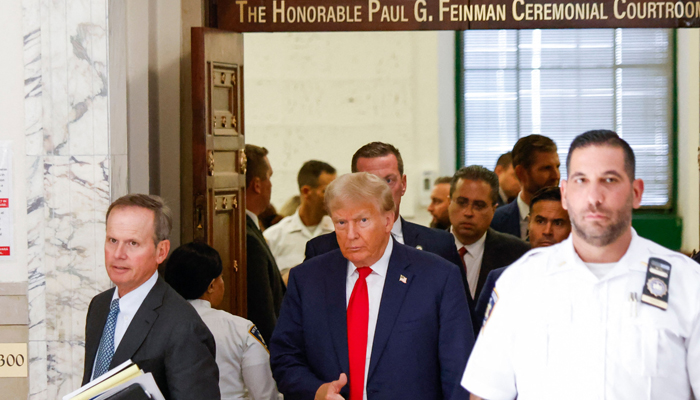 Former US President Donald Trump speaks to members of the media during the second day of his civil fraud trial in New York on October 3, 2023. — AFP