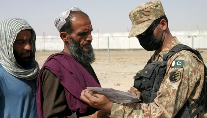 A Pakistani soldier checks documents of people arriving from Afghanistan at the Friendship Gate crossing point in the Pakistan-Afghanistan border town of Chaman, Pakistan August 27, 2021.—Reuters