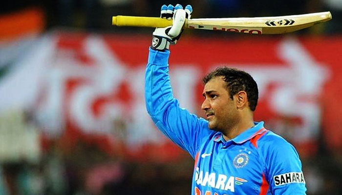 Former Indian opener Virender Sehwag raising his bat during a cricket match in this undated image. — AFP/File