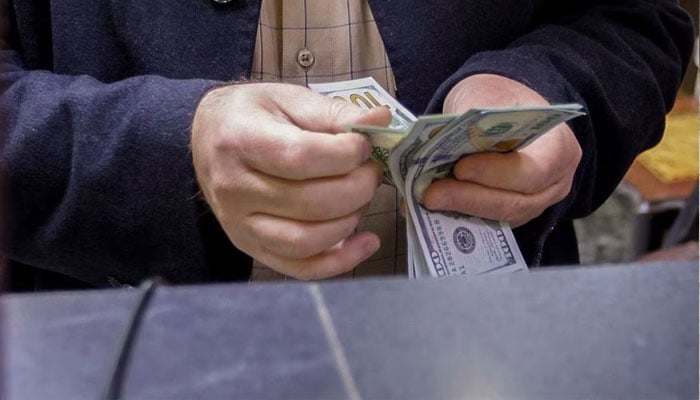 A man counts US dollars at a currency exchange shop in Baghdad, Iraq, January 23, 2023.—Reuters