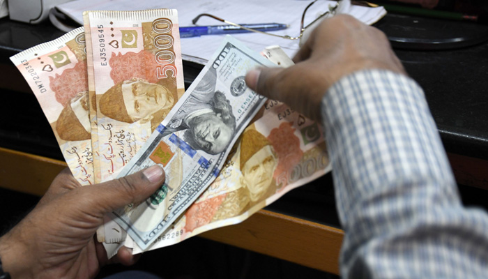 A foreign currency dealer counts US dollars at a shop in Karachi on March 2, 2023. — Online