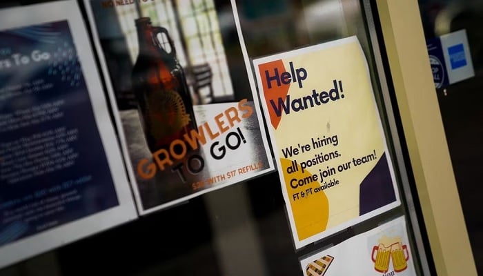 An employee hiring sign is seen in a window of a business in Arlington, Virginia, US, April 7, 2023. — Reuters/File